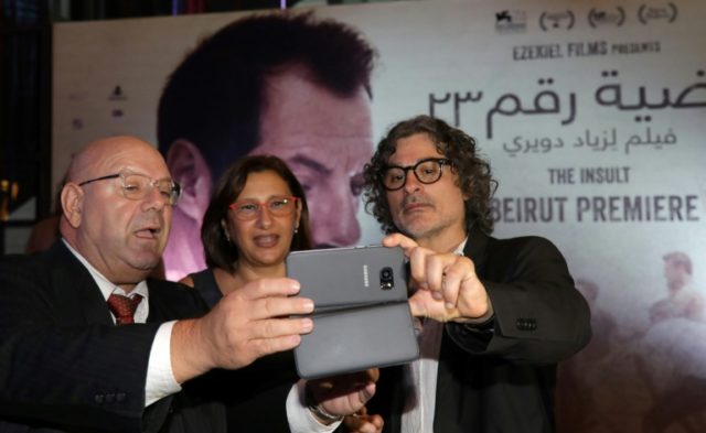 Lebanese-French director Ziad Douieri poses with actors fpr a selfie at the pre-screening