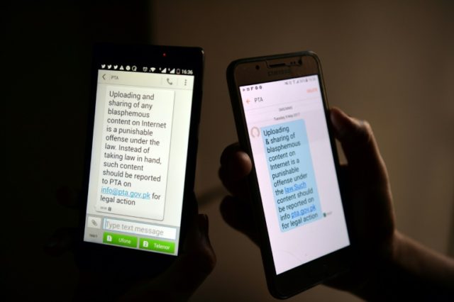 Pakistani cellphone users read a text message circulated by telecoms authorities reminding