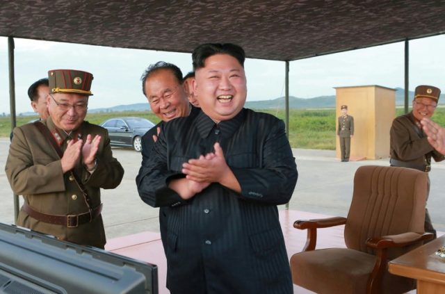 North Korean leader Kim Jong-Un (C) inspecting a launching drill of the medium-and-long range strategic ballistic rocket Hwasong-12 at an undisclosed location