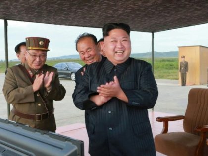 North Korean leader Kim Jong-Un (C) inspecting a launching drill of the medium-and-long range strategic ballistic rocket Hwasong-12 at an undisclosed location