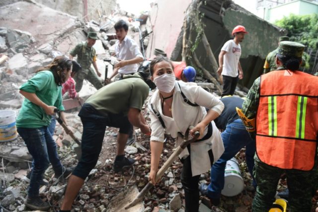 Rescuers, firefighters, policemen, soldiers and volunteers desperately remove rubble and d