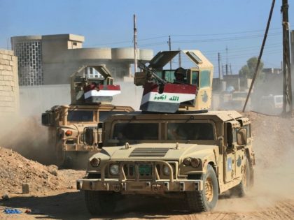 Humvees of the combined Iraqi forces and Popular Mobilization units advance through the to