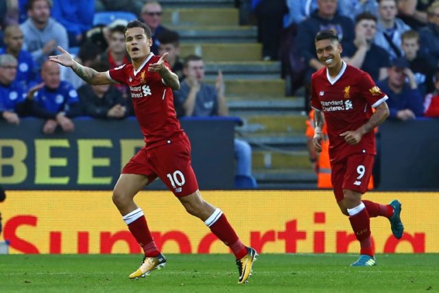 Liverpool midfielder Philippe Coutinho (L) celebrates after scoring his second goal from a