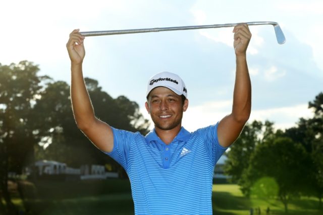 Xander Schauffele of the US celebrates with the Calamity Jane trophy on the 18th green aft