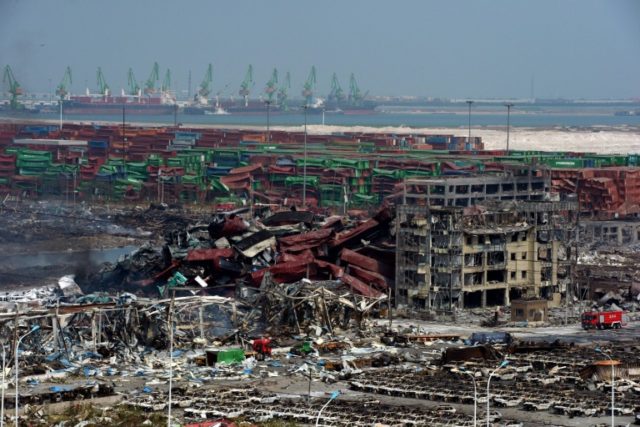 Mangled cargo containers and twisted wreckage at the site of the explosions in Tianjin in