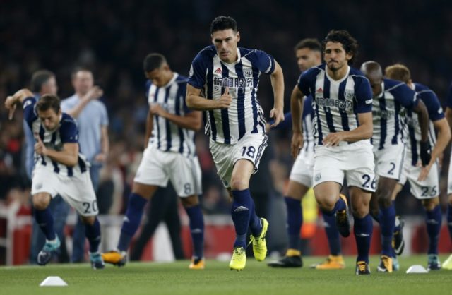 West Bromwich Albion midfielder Gareth Barry (C) runs on the pitch for his 633rd Premier L