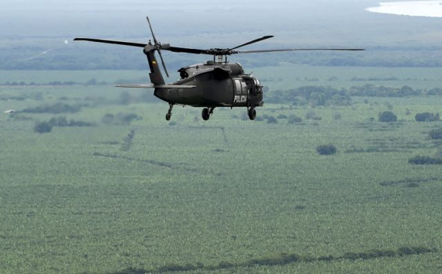 A helicopter used by Colombia's anti-narcotics police to throw pamphlets offering rewards