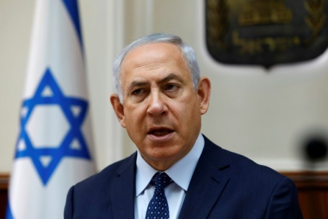 Israeli Prime Minister Benjamin Netanyahu opens the weekly cabinet meeting at his Jerusale