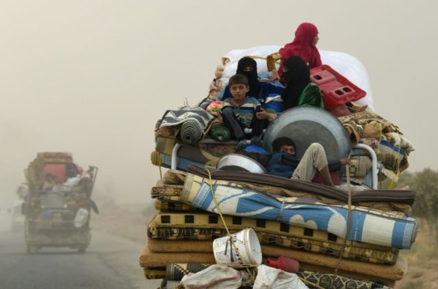 Displaced people head to refugee camps on the outskirts of Raqa, the onetime de facto Syri