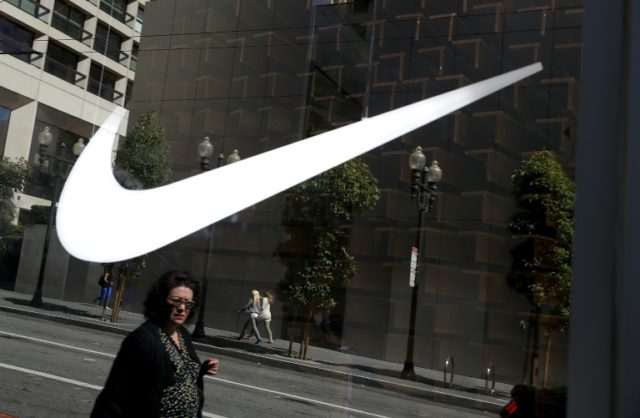 Nike reported a drop in first-quarter earnings on flat sales as heavy promotions in North