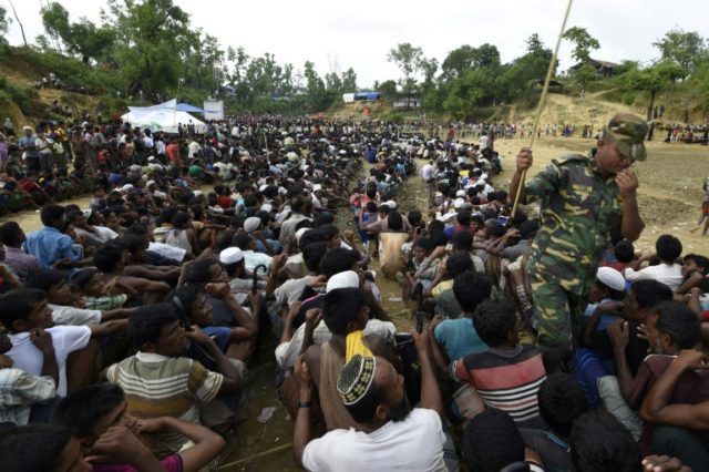 Rohingya Muslim refugees wait as food is distributed by the Bangladeshi army at Balukhali