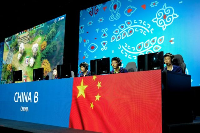 Members of the Chinese eSports team compete in the eSports tournament at the Asian Indoor