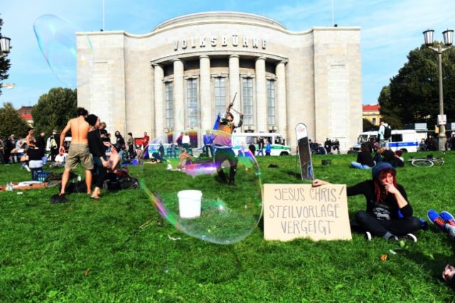 Protesters outside the Volksbuehne theatre in Berlin, where police removed those who had o