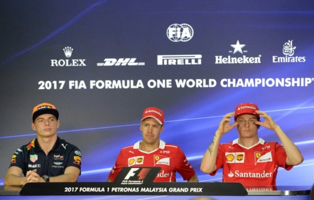 Ferrari drivers Sebastian Vettel (C) and Kimi Raikkonen (R) attend a press conference with