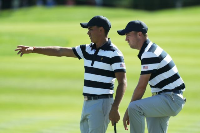 Rickie Fowler (L) and Justin Thomas of the US Team talk on the eighth green during the Pre