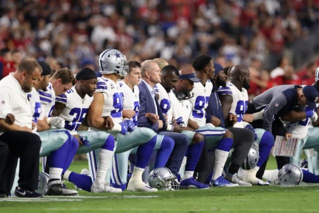 The Dallas Cowboys -- nicknamed "America's Team" -- linked arms and knelt on the field bef