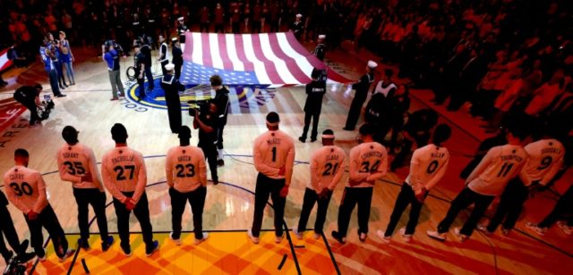 The Golden State Warriors line up for the national anthem during the 2017 NBA Finals again