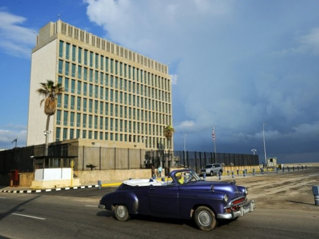 A vintage car drives by the US Embassy in Havana, which Secretary of State Rex Tillerson has said could be closed over mysterious attacks on American diplomats