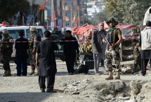 Policemen stand guard at the site of a suicide bomb attack near a Shiite mosque in Kabul o