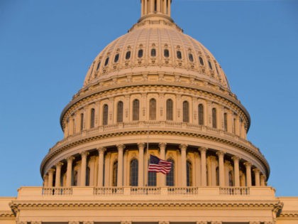 The American flag flies at half-staff over the U.S. Capitol at sunset following the shooti