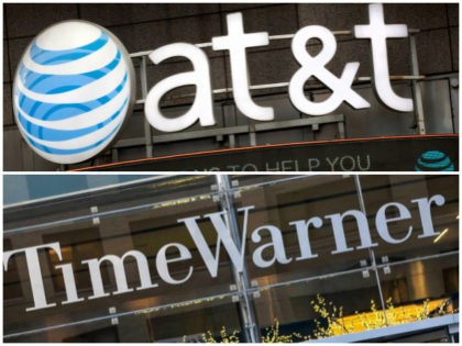 The AT&T logo is positioned above one of its retail stores, Monday, Oct. 24, 2016, in New York. AT&T plans to buy Time Warner for $85.4 billion. (AP Photo/Mark Lennihan)