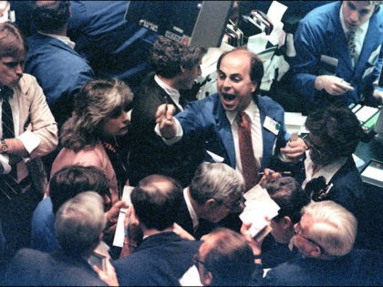 (FILES) A file photo dated 19 October, 1987 shows a trader (C) on the New York Stock Exchange shouting orders as stocks were devastated during one of the most frantic days in the exchange's history. The Dow Jones index plummeted 22.68 percent, some 508 points, to close at 1,738.41 points …