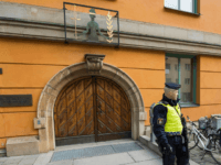GettyImages-667164274 Policemen secure the entrance to the Stockholm District Court where Uzbek national Rakhmat Akilov (not in picture), prime suspect in the Stockholm truck attack, appeared in court on April 11, 2017. 39-year-old Uzbek national Akilov suspected of mowing down a crowd of people on a busy Stockholm street in a …