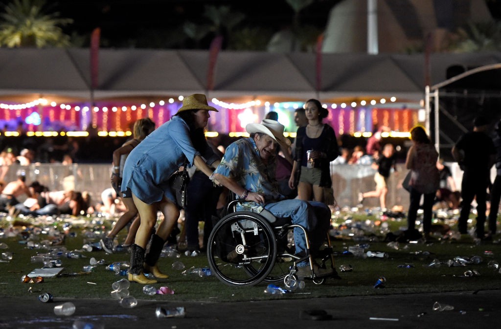 A man in a wheelchair is taken away from the Route 91 Harvest country music festival after apparent gun fire was heard on October 1, 2017 in Las Vegas, Nevada. There are reports of an active shooter around the Mandalay Bay Resort and Casino. (Photo by David Becker/Getty Images)