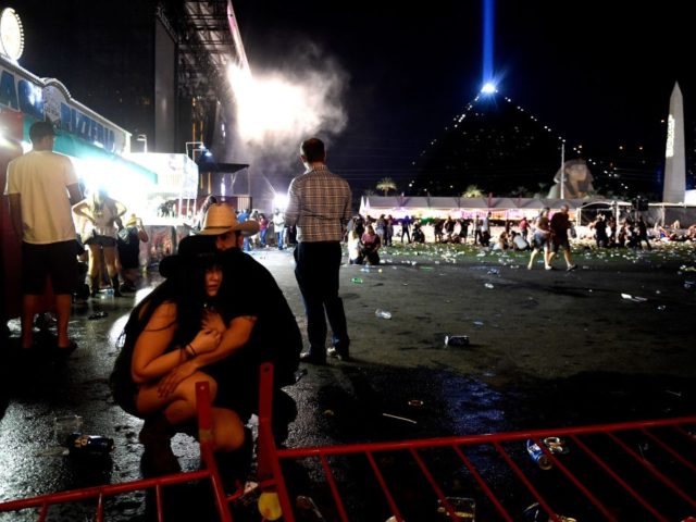LAS VEGAS, NV - OCTOBER 01: People take cover at the Route 91 Harvest country music festival after apparent gun fire was heard on October 1, 2017 in Las Vegas, Nevada. There are reports of an active shooter around the Mandalay Bay Resort and Casino. (Photo by David Becker/Getty Images)