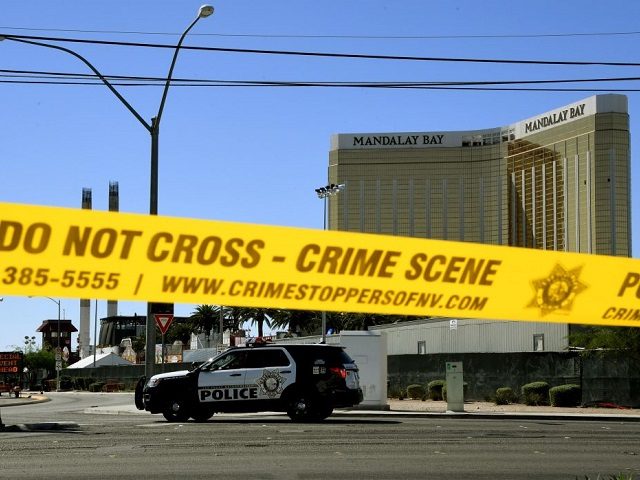 Crime scene tape surrounds the Mandalay Hotel (background with shooters window damage top right) after a gunman killed at least 58 people and wounded more than 500 others when he opened fire on a country music concert in Las Vegas, Nevada on October 2, 2017. Police said the gunman, a …