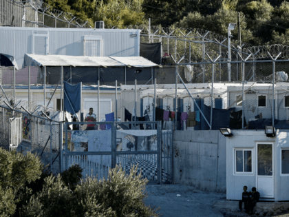 This photograph taken on October 13, 2017, shows an official government refugee shelter on the Greek island of Samos. Nearly 300 Syrians, Iraqis, Afghans and Africans from various countries live in this improvised camp located on a hill planted with olive trees, on this idyllic Greek island. They have arrived …