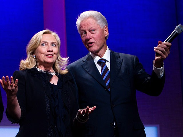 NEW YORK CITY- SEPTEMBER 22: Former US President Bill Clinton (R) stands on stage with his wife Hillary Rodham Clinton (C), Secretary of State, and their daughter Chelsea Clinton during the closing Plenary session of the seventh Annual Meeting of the Clinton Global Initiative (CGI) at the Sheraton New York …