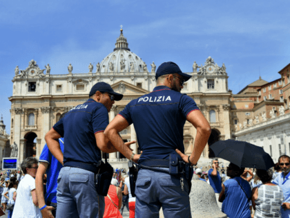 Italian police officers stand guard by people gathered in St. Peter's at the Vatican during Pope Francis Sunday Angelus prayer on July 24, 2016. / AFP / FILIPPO MONTEFORTE (Photo credit should read FILIPPO MONTEFORTE/AFP/Getty Images)
