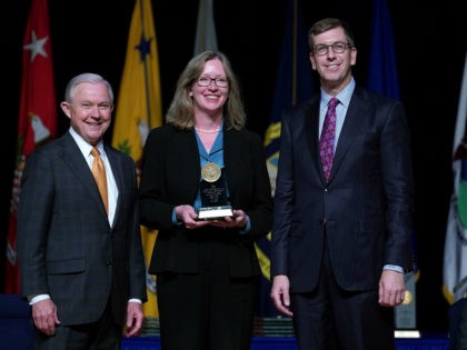U.S. Attorney General Jeff Sessions (L) poses for a photograph with Justice Department Civil Division Appellate Staff Assistant Director Sharon Swingle (C) during the 65th Annual Attorney General's Awards Ceremony at the Daughters of the American Revolution Constitution Hall October 25, 2017 in Washington, DC. Swingle was given The Attorney …