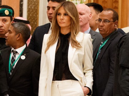 First Lady Melania Trump watches as President Donald Trump poses for photographs with leaders at Arab Islamic American Summit, at the King Abdulaziz Conference Center, Sunday, May 21, 2017, in Riyadh, Saudi Arabia. (AP Photo/Evan Vucci)