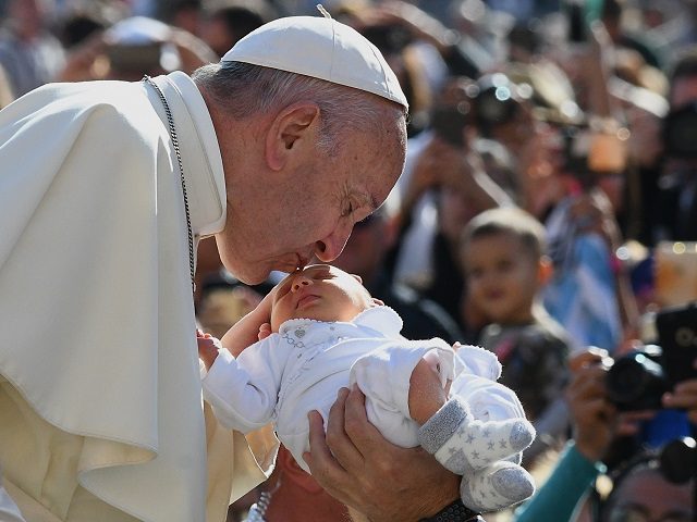 Pope Francis kisses a baby upon his arrival for his weekly general audience at St. Peter's square in the Vatican, on September 27, 2017. / AFP PHOTO / VINCENZO PINTO (Photo credit should read VINCENZO PINTO/AFP/Getty Images)