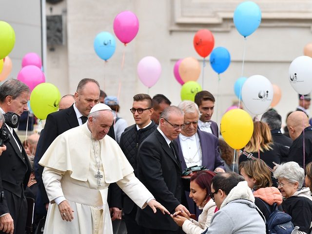 Pope Francis greets a group of partially sighted and blind people during his weekly genera
