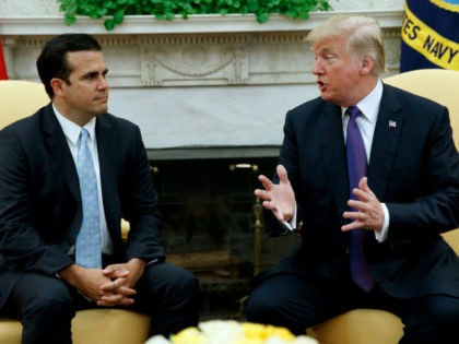 President Donald Trump meets with Governor Ricardo Rossello of Puerto Rico in the Oval Office of the White House, Thursday, Oct. 19, 2017, in Washington. (AP Photo/Evan Vucci)
