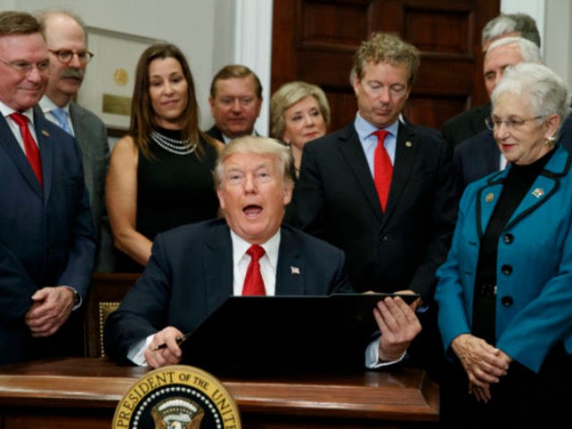 President Donald Trump speaks before signing an executive order on health care in the Roos
