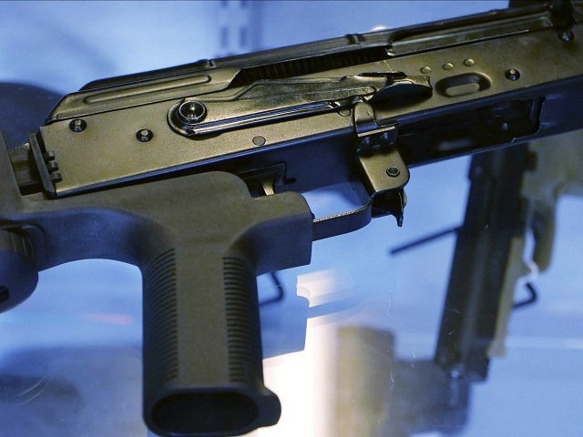 In this Oct. 4, 2017, photo, a device called a "bump stock" is attached to a semi-automatic rifle at the Gun Vault store and shooting range in South Jordan, Utah. The National Rifle Association announced its support Ton Oct. 5 for regulating the devices that can effectively convert semi-automatic rifles …