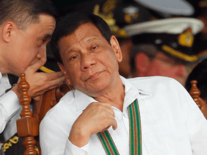 FILE - In this Oct. 5, 2017 file photo, Philippine President Rodrigo Duterte, right, listens to Special Assistant to the President Christopher Bong Go, during the change of command ceremony for the new army chief Maj. Gen. Rolando Joselito Bautista in Fort Bonifacio in, Taguig city, east of Manila, Philippines. …