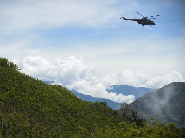 A helicopter of the Army overflies a coca field in Pueblo Nuevo, in the municipality of Briceno, Antioquia Department, Colombia, on May 15, 2017. The Colombian government and the Revolutionary Armed Forces of Colombia (FARC) leftist guerrillas inaugurated a plan to eradicate coca plantations and replace them with legal crops. …