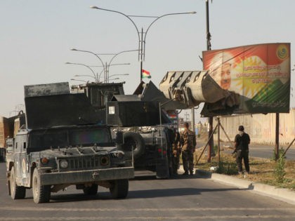 KIRKUK, IRAQ - OCTOBER 16: Iraqi troops demolish a billboard, depicting Iraqi Kuridish Reg