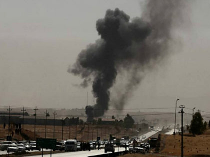 Smoke rises while Iraqi security forces use bombs as Kurdish security forces withdraw from