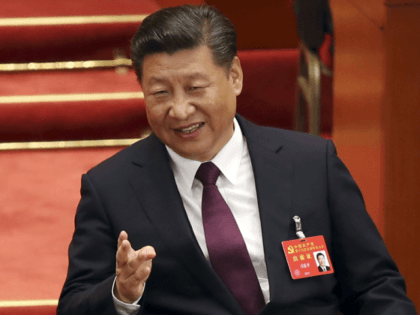 FILE - In this Oct. 18, 2017 file photo, Chinese President Xi Jinping talks with former Chinese President Hu Jintao during the opening session of China's 19th Party Congress at the Great Hall of the People in Beijing. China’s economic growth stayed relatively stable in the latest quarter, buoyed by …