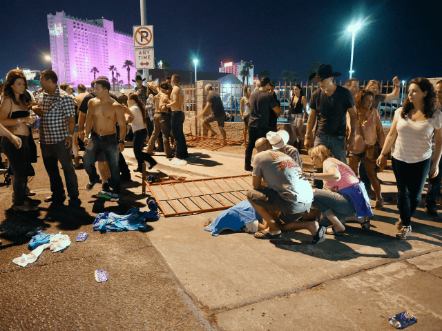 LAS VEGAS, NV - OCTOBER 01: People tend to the wounded outside the Route 91 Harvest Countr
