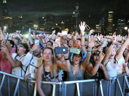 In this Aug 5, 2017, file photo, concertgoers attend day 3 of Lollapalooza in Grant Park on in Chicago. Stephen Paddock, opened fire on an outdoor music concert on Sunday, Oct. 1, killing dozens and injuring hundreds in Las Vegas. In August, Paddock, booked a room at Chicago's Blackstone Hotel …