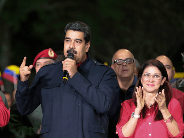 Venezuelan President Nicolas Maduro (R) speaks beside First lady Cilia Flores (R) and Diosdado Cabello (L), a member of the Constituent Assembly, in Caracas on October 15, 2017, after Maduro's socialist government won a landslide 17 out of 23 states in Venezuela's regional elections, according to official results announced by …