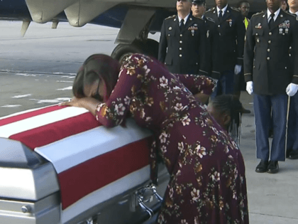 ADDS TRUMP'S RESPONSE TO REP. WILSON - In this Tuesday, Oct. 17, 2017, frame from video, Myeshia Johnson cries over the casket of her husband, Sgt. La David Johnson, who was killed in an ambush in Niger, upon his body's arrival in Miami. President Donald Trump told the widow that …