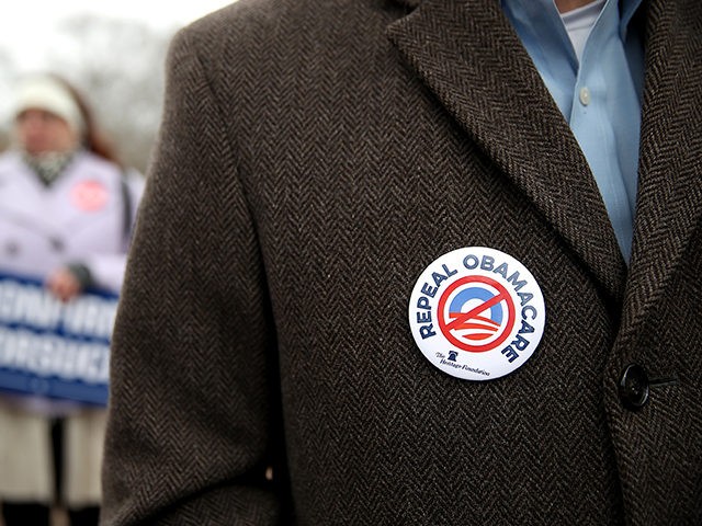 WASHINGTON, DC - MARCH 15: A protester wears a Repeal Obamacare button on his jacket during a Freedom Works rally against the proposed GOP health care plan at Upper Senate Park across from the U.S. Capitol on March 15, 2017 in Washington, DC. Hundreds of protesters with the conservative group …